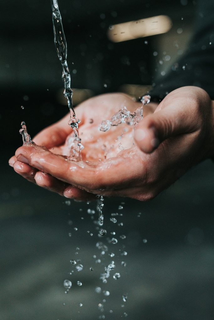 Fresh water pooring in hands